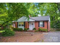 Charming brick home featuring lush landscaping and inviting curb appeal at 4647 General Pershing Dr, Charlotte, NC 28209