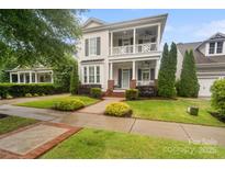 Charming two-story home featuring a welcoming porch and beautifully landscaped front yard at 5663 Morris Hunt Dr, Fort Mill, SC 29708