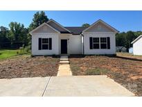 Charming single-story home with a symmetrical design and a well-manicured front lawn at 601 Queens Rd, Gastonia, NC 28052