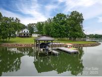 Stunning waterfront property with boat dock and lush green landscaping at 7455 Ivey Dr, Sherrills Ford, NC 28673