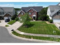 Beautiful brick home featuring a well-manicured lawn and a classic, symmetrical design at 9612 Indian Beech Nw Ave # 1266, Concord, NC 28027