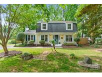Charming home with dormer windows and a lush front yard with mature trees and landscaping at 1014 Vandalia Dr, Charlotte, NC 28212