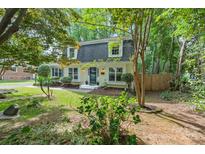 Charming Cape Cod home featuring a well-maintained lawn, lush landscaping and classic architectural details at 1014 Vandalia Dr, Charlotte, NC 28212