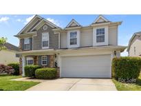 Charming two-story home featuring a two-car garage, stone accents, and manicured landscaping at 10418 Cullen Ct, Charlotte, NC 28278