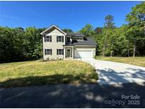 Charming two-story home with a well-manicured lawn, attached garage, and classic architectural details at 1563 Riverview Cir, Fort Lawn, SC 29714