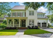 Charming two-story home with a covered front porch, beautiful lawn, and two-car garage at 201 Mills Ln, Fort Mill, SC 29708
