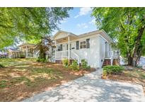 Charming white brick home with a cozy front porch, landscaped yard, and inviting curb appeal at 2109 Brewton Dr, Charlotte, NC 28206