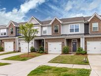 Charming townhome exteriors feature brick accents, one-car garages, and well-maintained landscaping at 2141 Bexar Trl, Matthews, NC 28105