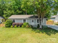 Charming single-story home with well-manicured lawn and welcoming front porch, perfect for relaxing outdoors at 21614 Colina Dr, Cornelius, NC 28031