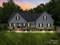 Charming traditional home featuring a well-manicured lawn and inviting front porch at 2608 Henry Baucom Rd, Monroe, NC 28110