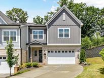 Charming two-story home with gray siding, brick accents, a two-car garage, and a well-manicured front yard at 3135 Everly Enclave Way, Charlotte, NC 28210