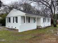 Charming white-brick ranch home featuring black shutters, covered porch, and a well-maintained front yard at 3701 Tipperary Pl, Charlotte, NC 28215