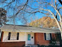 Charming single-story home with brick accents and a well-maintained front yard under a blue sky at 3701 Tipperary Pl, Charlotte, NC 28215