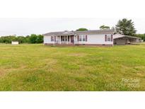 Well-maintained single-story home with a large front yard and covered porch, perfect for enjoying the outdoors at 404 St Lukes Church Rd, Kings Mountain, NC 28086