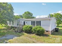 Charming single-Gathering home with a landscaped front yard and inviting entryway at 4122 Canal Rd, Marshville, NC 28103