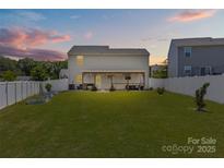 Spacious backyard featuring a covered patio perfect for outdoor entertaining and lush lawn space at 5325 Merwyn Ave, Charlotte, NC 28215