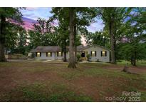Charming one-story home featuring a lush front yard and inviting walkway at 603 Sunnybrook Dr, Monroe, NC 28110