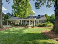Charming single-story home featuring a manicured lawn and a covered carport, offering both style and convenience at 1069 Sedgefield Rd, Charlotte, NC 28209