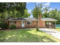 Charming single-story brick home with a well-maintained front yard and inviting covered porch at 128 Paul Snipes Rd, Lancaster, SC 29720