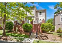 Charming two-story home featuring a brick foundation, front porch, and well-maintained landscaping at 14940 Carbert Ln, Huntersville, NC 28078