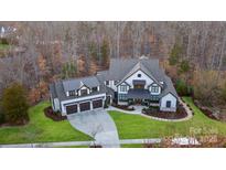 Stunning home with three car garage, manicured lawn and mature trees at 17416 Gillican Overlook Rd, Davidson, NC 28036