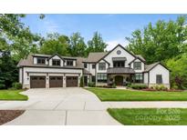 A beautiful two-story home with a three-car garage and manicured lawn in a well-developed neighborhood at 17416 Gillican Overlook Rd, Davidson, NC 28036
