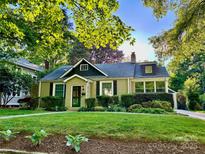 Charming bungalow-style home with a well-manicured lawn and mature landscaping creating a serene curb appeal at 1809 The Plaza None, Charlotte, NC 28205