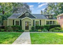 Charming home with a well-manicured lawn and stone walkway leading to the front door at 1809 The Plaza None, Charlotte, NC 28205