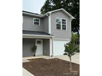 Charming two-story home with gray siding, white trim, and a one-car garage with a freshly landscaped yard at 2012 Crown Point Dr # A, Albemarle, NC 28001