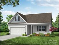 Charming one-story home with a covered porch and a well-manicured front lawn, perfect for a growing Gathering at 2608 Wild Azalea Ct # 9, Monroe, NC 28110