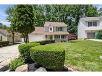 Charming two-story home with a well-manicured lawn and lovely front porch at 6640 Autumn Gate Ln, Charlotte, NC 28216