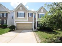 Charming two-story home with a two-car garage and well-maintained landscaping at 8317 Dallas Bay Rd, Charlotte, NC 28278
