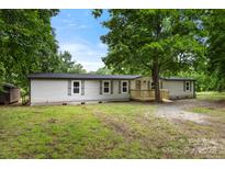 Inviting single-story home featuring light siding and a charming wooden porch at 925 Crestland Dr, Clover, SC 29710