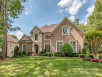 Beautiful brick home with a well-manicured lawn and lush landscaping at 10924 Lederer Ave, Charlotte, NC 28277
