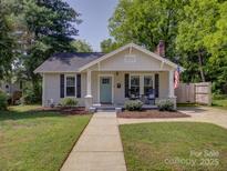 Charming bungalow with a manicured lawn, a quaint porch, and a sidewalk leading to the front door at 1324 E 35Th St, Charlotte, NC 28205