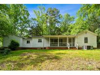 View of home's rear exterior showing the screened-in porch and ample backyard space at 1917 Tom Sadler Rd, Charlotte, NC 28214