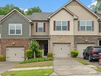 Charming townhome with brick and siding facade, complemented by a well-maintained front lawn at 234 Ascot Run Way, Fort Mill, SC 29715