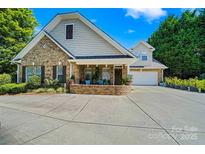 Charming brick home features a two-car garage, large front porch, and well-maintained landscaping at 286 Liverpool Rd, Rock Hill, SC 29730