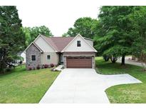 Beautiful home featuring stone accents, neutral siding, a brown roof, and a spacious two-car garage at 3670 9Th Street Ne Dr # 96, Hickory, NC 28601