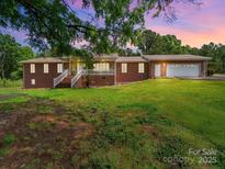 Charming brick home with lush lawn, front porch and ample parking at 40278 Nc 740 Hwy, New London, NC 28127