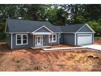 Charming single-story home with gray siding, white trim, and a welcoming front porch at 415 Dogwood Ln, Statesville, NC 28625