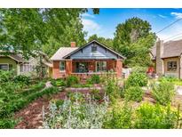 Charming brick home features a lush landscaped front yard with walkway and covered porch at 510 Wiley Ave, Salisbury, NC 28144