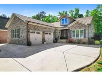 Beautiful brick home featuring a two-car garage and well-maintained landscaping at 6010 Albiza Dr, Harrisburg, NC 28075
