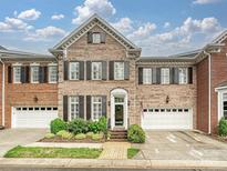 Charming brick townhome with black shutters, well-maintained landscaping, and a welcoming entrance at 6309 Wakehurst Rd, Charlotte, NC 28226