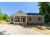 Charming home featuring a welcoming front porch and gray siding with attractive wooden shutters at 7426 Hambright Rd, Huntersville, NC 28078