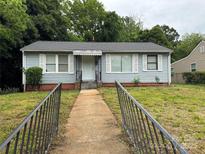 Charming single-story home featuring a well-maintained front yard and classic architectural details at 1101 Mona Dr, Charlotte, NC 28206