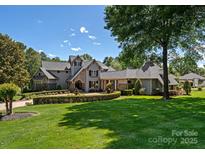 Stately home boasts manicured landscaping, a circular driveway, and classic architectural details at 143 Jeremy Point Pl, Mooresville, NC 28117