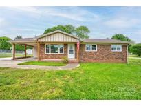 Charming single story brick home with a covered carport and well maintained lawn at 1690 Montevista Dr, Shelby, NC 28150