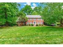 Charming two-story brick home with a manicured lawn and mature trees offering curb appeal at 2730 Tiffany Dr, Rock Hill, SC 29732