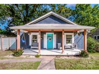 Charming bungalow with a bright blue front door, inviting porch, and meticulous landscaping at 310 Patterson Ave, Mooresville, NC 28115